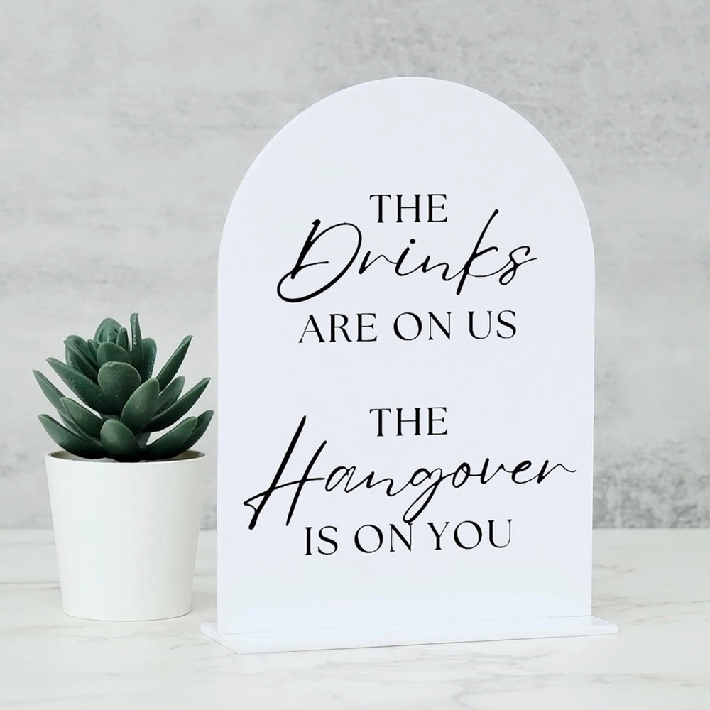 Black and white Wedding sign. The drinks are on us the hangover is on you